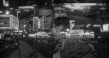 Movie still from “Love with the Proper Stranger” (1963), directed by Robert Mulligan – A black - and - white photo of a man in a suit; Close Up shot, High angle