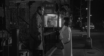 Movie still from “Love with the Proper Stranger” (1963), directed by Robert Mulligan – A man and a woman standing on a sidewalk; Medium shot, Over the shoulder angle