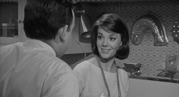 Movie still from “Love with the Proper Stranger” (1963), directed by Robert Mulligan – An old photo of a man and a woman talking to each other; Close Up shot, Over the shoulder angle