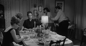 Movie still from “Love with the Proper Stranger” (1963), directed by Robert Mulligan – A group of people sitting around a table with food on it; Medium shot, High angle