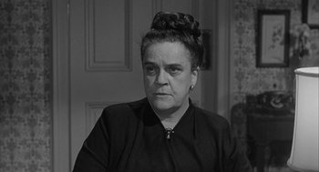 Movie still from “Love with the Proper Stranger” (1963), directed by Robert Mulligan – An old photo of an older woman in a black dress; Close Up shot, High angle