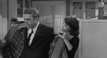 Movie still from “Love with the Proper Stranger” (1963), directed by Robert Mulligan – A man and a woman in a suit and tie; Medium shot, Over the shoulder angle