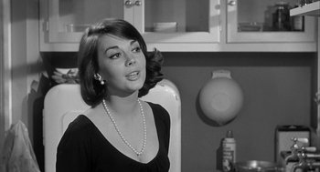 Movie still from “Love with the Proper Stranger” (1963), directed by Robert Mulligan – A black and white photo of a woman in a black dress; Close Up shot, Over the shoulder angle