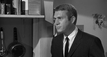 Movie still from “Love with the Proper Stranger” (1963), directed by Robert Mulligan – Black and white photograph of a man wearing a suit and tie; Close Up shot, Over the shoulder angle