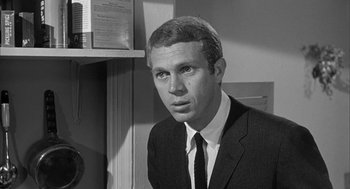 Movie still from “Love with the Proper Stranger” (1963), directed by Robert Mulligan – Black and white photograph of a man wearing a suit; Close Up shot, Low angle