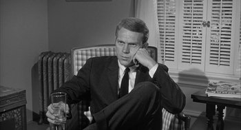 Movie still from “Love with the Proper Stranger” (1963), directed by Robert Mulligan – A black and white photo of a man sitting in a chair; Close Up shot, Over the shoulder angle