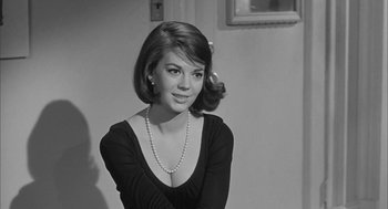 Movie still from “Love with the Proper Stranger” (1963), directed by Robert Mulligan – Black and white photograph of a young woman wearing a necklace; Close Up shot, Over the shoulder angle