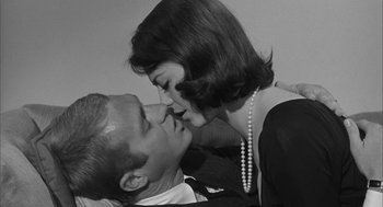 Movie still from “Love with the Proper Stranger” (1963), directed by Robert Mulligan – A man and a woman are kissing in a room; Close Up shot, Low angle