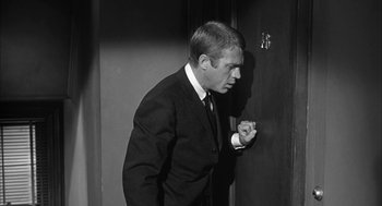 Movie still from “Love with the Proper Stranger” (1963), directed by Robert Mulligan – Black and white photograph of a man smoking a cigarette; Medium shot, Over the shoulder angle