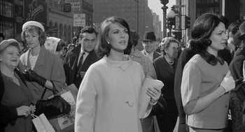 Movie still from “Love with the Proper Stranger” (1963), directed by Robert Mulligan – A woman is walking down a crowded city street; Medium shot, Low angle