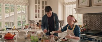 Movie still from “Love, Simon” (2018), directed by Greg Berlanti – A man and a little girl in the kitchen preparing food; Medium shot, Over the shoulder angle