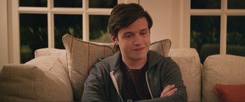 Movie still from “Love, Simon” (2018), directed by Greg Berlanti – A man sitting on top of a couch with his arms crossed; Close Up shot, Over the shoulder angle