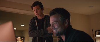 Movie still from “Love, Simon” (2018), directed by Greg Berlanti – A young man standing in front of another man; Medium shot, Over the shoulder angle