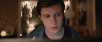 Movie still from “Love, Simon” (2018), directed by Greg Berlanti – A young man looking at the camera while sitting in front of a computer screen; Close Up shot, Over the shoulder angle