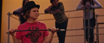 Movie still from “Love, Simon” (2018), directed by Greg Berlanti – A man holding a stick in front of another man; Medium shot, Over the shoulder angle