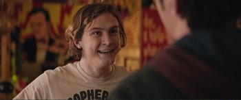 Movie still from “Love, Simon” (2018), directed by Greg Berlanti – A young man with long hair is smiling at the camera; Close Up shot, Over the shoulder angle
