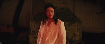 Movie still from “Love, Simon” (2018), directed by Greg Berlanti – A man with long black hair wearing a white suit; Medium shot, Low angle