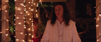 Movie still from “Love, Simon” (2018), directed by Greg Berlanti – A man with long hair wearing a white jacket; Medium shot, Over the shoulder angle
