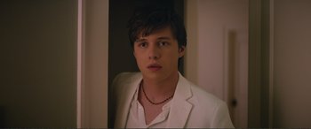 Movie still from “Love, Simon” (2018), directed by Greg Berlanti – A young man in a white suit looking at the camera; Close Up shot, Over the shoulder angle