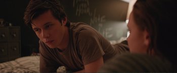 Movie still from “Love, Simon” (2018), directed by Greg Berlanti – A man laying on the ground in front of a chalkboard; Close Up shot, Over the shoulder angle