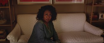 Movie still from “Love, Simon” (2018), directed by Greg Berlanti – A woman sitting on top of a couch in front of a window; Close Up shot, Over the shoulder angle