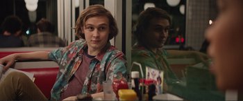 Movie still from “Love, Simon” (2018), directed by Greg Berlanti – A man sitting in front of a mirror in front of a window; Medium shot, Over the shoulder angle