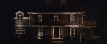 Movie still from “Love, Simon” (2018), directed by Greg Berlanti – A man standing on a balcony of a house at night; Extreme Wide shot, Low angle