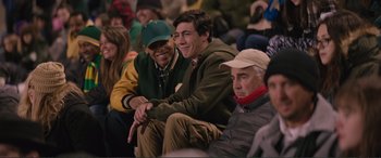 Movie still from “Love, Simon” (2018), directed by Greg Berlanti – A group of men sitting next to each other in a crowd; Medium shot, Over the shoulder angle