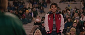 Movie still from “Love, Simon” (2018), directed by Greg Berlanti – A person standing in front of a group of people; Medium shot, Over the shoulder angle