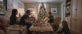 Movie still from “Love, Simon” (2018), directed by Greg Berlanti – Two men sitting in front of a decorated christmas tree; Wide shot, Over the shoulder angle