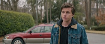 Movie still from “Love, Simon” (2018), directed by Greg Berlanti – A young man standing in front of a red car; Close Up shot, Over the shoulder angle