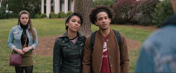 Movie still from “Love, Simon” (2018), directed by Greg Berlanti – A couple of people standing next to each other in front of a tree; Close Up shot, Low angle