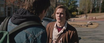 Movie still from “Love, Simon” (2018), directed by Greg Berlanti – Two young men standing next to each other on a street; Close Up shot, Over the shoulder angle