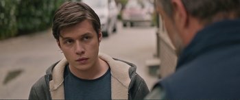 Movie still from “Love, Simon” (2018), directed by Greg Berlanti – A man standing on the side of the street looking into the distance; Close Up shot, Over the shoulder angle