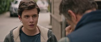 Movie still from “Love, Simon” (2018), directed by Greg Berlanti – A man standing next to another man on the street; Close Up shot, Over the shoulder angle