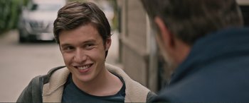 Movie still from “Love, Simon” (2018), directed by Greg Berlanti – A young man smiling while talking to another man; Close Up shot, Over the shoulder angle