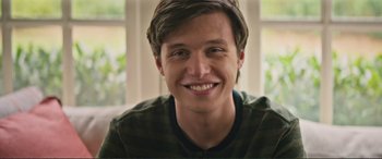 Movie still from “Love, Simon” (2018), directed by Greg Berlanti – A person smiling for the camera; Close Up shot, Low angle