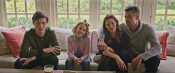 Movie still from “Love, Simon” (2018), directed by Greg Berlanti – A group of people sitting on top of a white couch; Medium shot, Over the shoulder angle