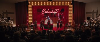 Movie still from “Love, Simon” (2018), directed by Greg Berlanti – A group of people on a stage performing a show; Extreme Wide shot, High angle