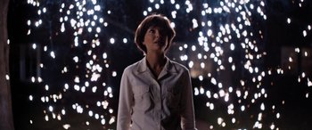 Movie still from “Lucy in the Sky” (2019), directed by Noah Hawley – A woman standing in front of a bunch of lights; Medium shot, Low angle