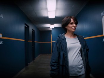 Movie still from “Lucy in the Sky” (2019), directed by Noah Hawley – A woman standing in a hallway in a building; Medium shot, Low angle