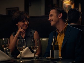 Movie still from “Lucy in the Sky” (2019), directed by Noah Hawley – A man and a woman sitting at a table with wine glasses; Medium shot, Over the shoulder angle