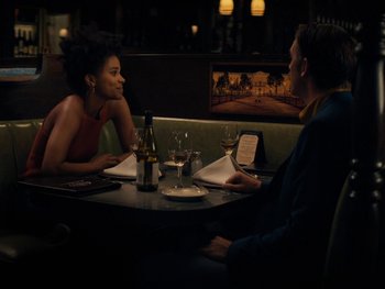 Movie still from “Lucy in the Sky” (2019), directed by Noah Hawley – A man and a woman sitting at a table with wine glasses; Medium shot, Over the shoulder angle