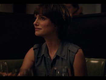 Movie still from “Lucy in the Sky” (2019), directed by Noah Hawley – A woman sitting at a table with a glass of wine in front of her; Close Up shot, Over the shoulder angle