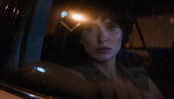 Movie still from “Lucy in the Sky” (2019), directed by Noah Hawley – A woman sitting in a car looking out the window at night; Close Up shot, Over the shoulder angle