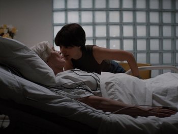 Movie still from “Lucy in the Sky” (2019), directed by Noah Hawley – A man laying in a bed with a woman; Medium shot, High angle