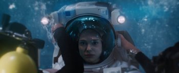Movie still from “Lucy in the Sky” (2019), directed by Noah Hawley – A woman in a space suit looking into a mirror; Close Up shot, Overhead angle