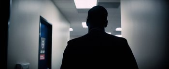 Movie still from “Lucy in the Sky” (2019), directed by Noah Hawley – A man in a suit is standing in a hallway; Extreme Close Up shot, Low angle