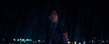 Movie still from “Lucy in the Sky” (2019), directed by Noah Hawley – A woman standing in the rain at night; Medium shot, Low angle