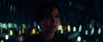 Movie still from “Lucy in the Sky” (2019), directed by Noah Hawley – A person in the rain with lights in the background; Close Up shot, Low angle